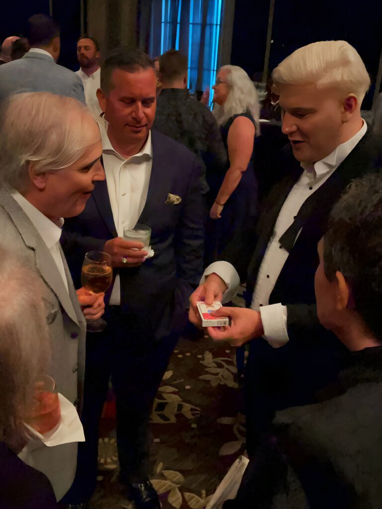 close up magician miami david frost entertaining guests